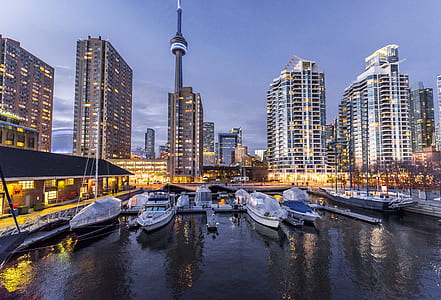 boats on body of water near building during daytime thumbnail