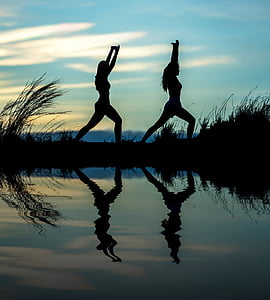 two woman standing on field under blue skies during daytime thumbnail