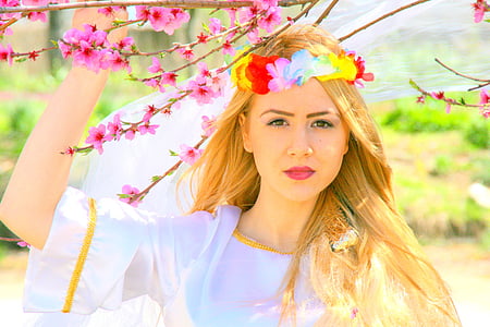 woman wearing red lipstick holding pink flowers during daytime thumbnail
