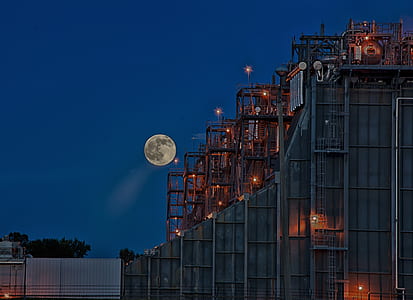 gray concrete building under full moon thumbnail