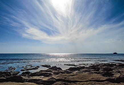 brown rock near body of water photo thumbnail