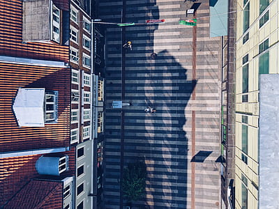 top-view photography of pathway between buildings at daytime thumbnail