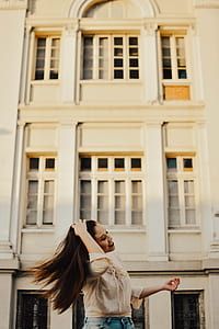 woman standing in front of white building thumbnail