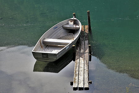 gray boat on body of water at daytime thumbnail