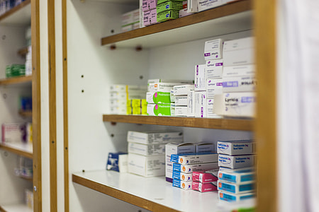 white medicine boxes on brown and white wooden shelf thumbnail