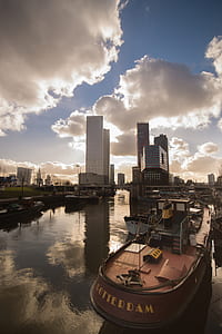 boat on dock near city building thumbnail