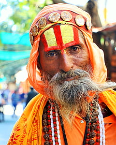 man wearing orange and yellow dress thumbnail