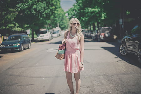 woman wearing pink scoop-neck sleeveless dress at street thumbnail