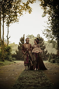 Man and Woman in Traditional Clothing Near Angkor Wat thumbnail