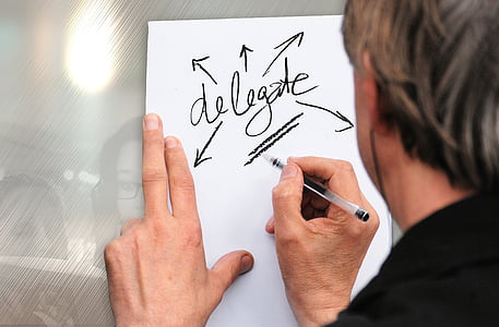 person writing on white paper thumbnail