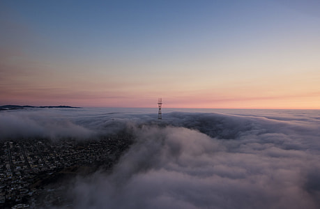 aerial photograph of a city under orange cloudy skies thumbnail