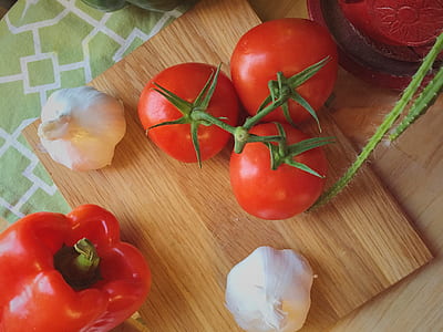 four tomatoes on brown wooden board thumbnail