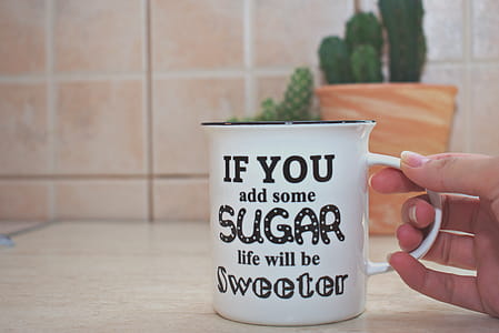 Person Holding White And Black Ceramic Mug thumbnail