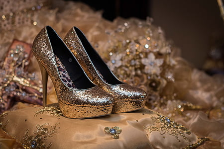 pair of gold glitter-type platform pumps on bed thumbnail