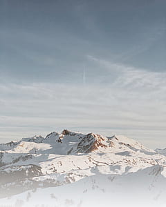 snowy mountain under cloudy sky thumbnail