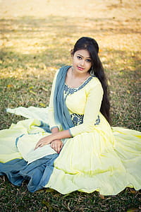 Selective Focus Photography of Woman Sitting on Green Grass thumbnail