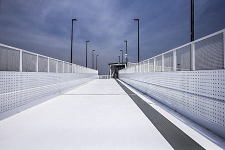 pathway between white mesh fence thumbnail