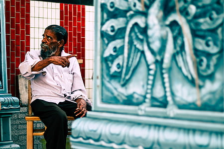 man pointing at wall decor thumbnail