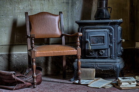 brown armchair beside black wood stove thumbnail