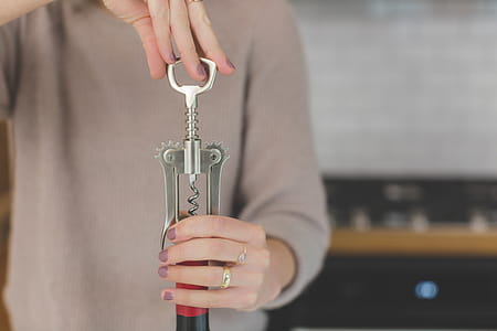 Person Holding Grey and Red Hand Tool thumbnail
