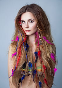 woman wearing bikini top with feather hair accessories thumbnail