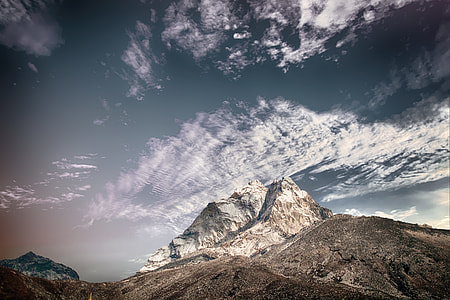 low angle photography of mountain under clouds thumbnail