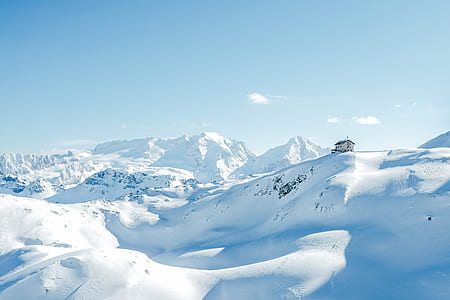photo of house on glacier mountain under blue sky thumbnail