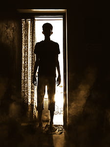 man standing near black and gray curtain thumbnail