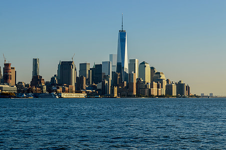 city buildings standing beside body of water thumbnail