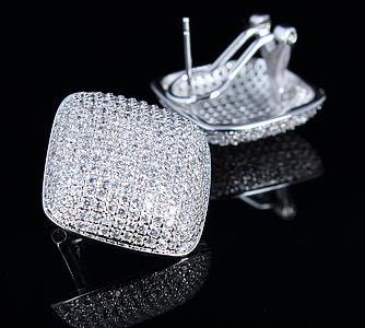pair of silver-colored stud earrings on top of black surface thumbnail