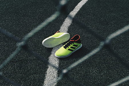 selective focus photo of green-and-black adidas running shoes thumbnail