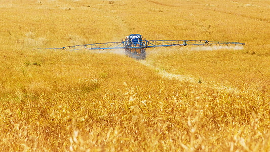 black harvester on field during daytime thumbnail