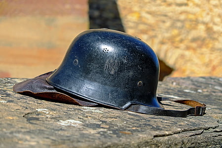black military hat on gray rock thumbnail