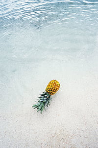 yellow pineapple floating on water thumbnail
