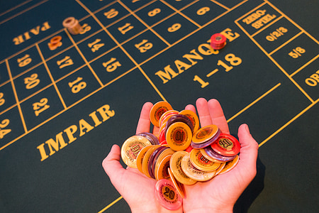 person holding poker chips thumbnail