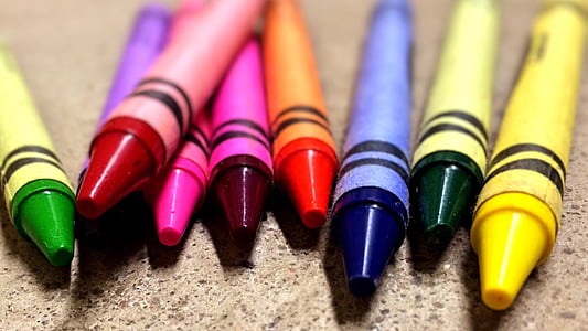 shallow focus photography of crayons on brown surface thumbnail