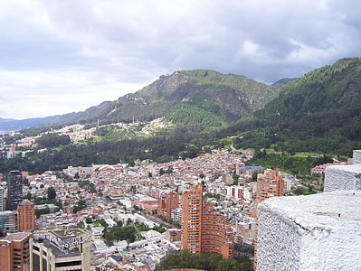 low angle view of high rise building near mountains thumbnail