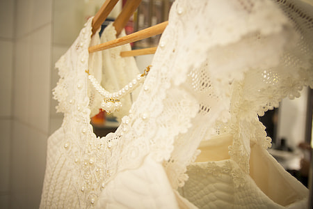 white floral sleeveless dress in closeup photography thumbnail
