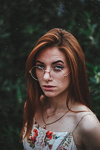 woman standing wearing round eyeglasses with silver frames outdoors thumbnail