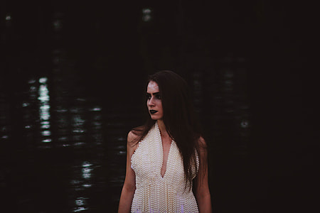 woman wearing halterneck top near body of water thumbnail