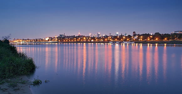 light-on building near body of water thumbnail