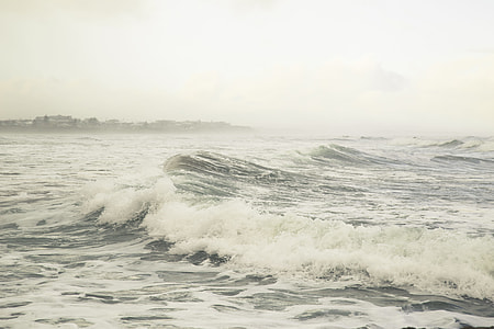 seawave with foam under white sky at daytime thumbnail