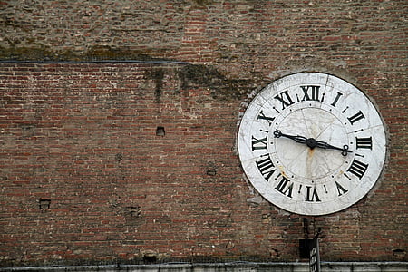 round white analog clock on wall at daytime thumbnail