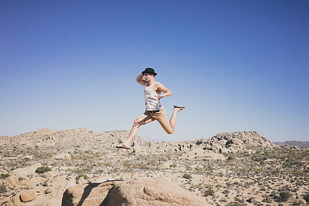 man leaping over beige stone near savannah thumbnail