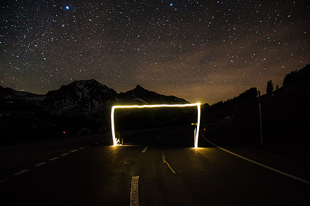 selective focus photography of clear road under stars thumbnail
