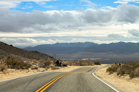 photo of gray asphalt road towards mountain range thumbnail