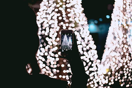 person taking photo into lights thumbnail