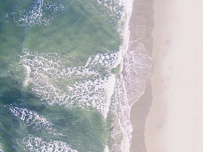 green and brown sea near seashore thumbnail