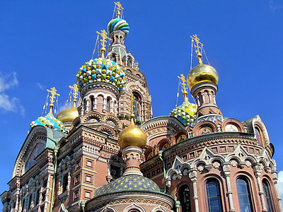 low angle photography of brown and brown church under blue sky background thumbnail