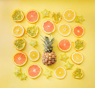pineapple surrounded by sliced fruits thumbnail